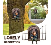 Mischievous garden gnome voyeur, funny garden tree decoration